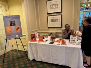 Larry speaking with an attendee at the book signing